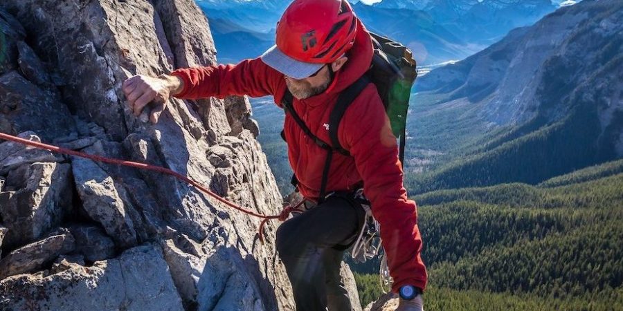 A man rock climbing outdoors in Alberta, Canada