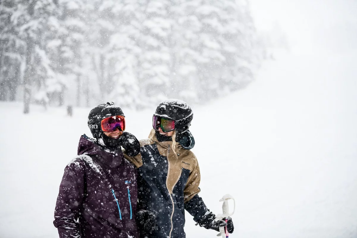 A couple in snowfall at Whistler, BC