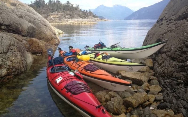 Sea kayaks ready for an LGBTQ+ outdoor adventure