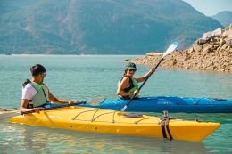 Two People Kayaking On The Ocean On An Outdoor Adventure