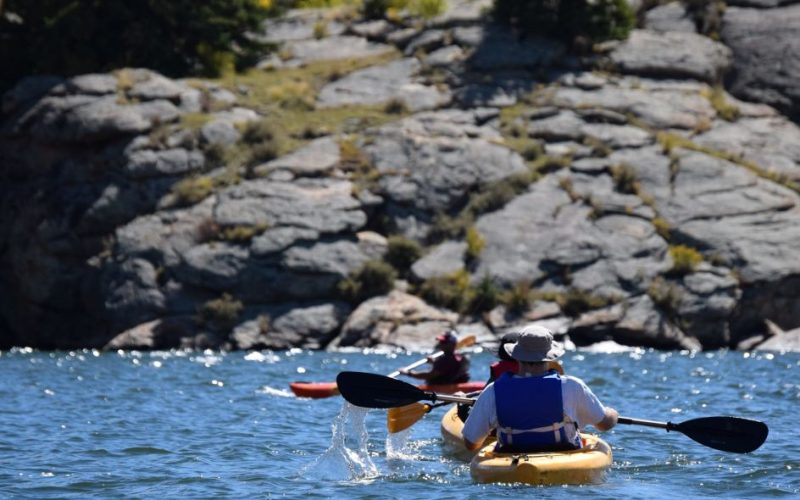two people sea kayaking on yellow canoes in Trinity Bay, Newfoundland