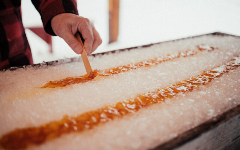 Maple syrup in snow at a sugar shack or cabane a sucre in Quebec